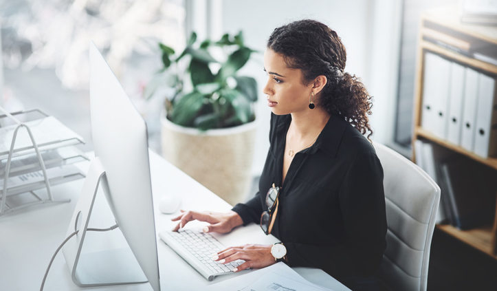 Woman at desk in office doing market research