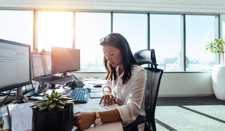 Woman entrepreneur at work in office. SharePoint is not an ideal solution for market research.