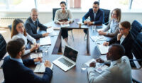 Business people at panel discussion in board room discussing generative AI