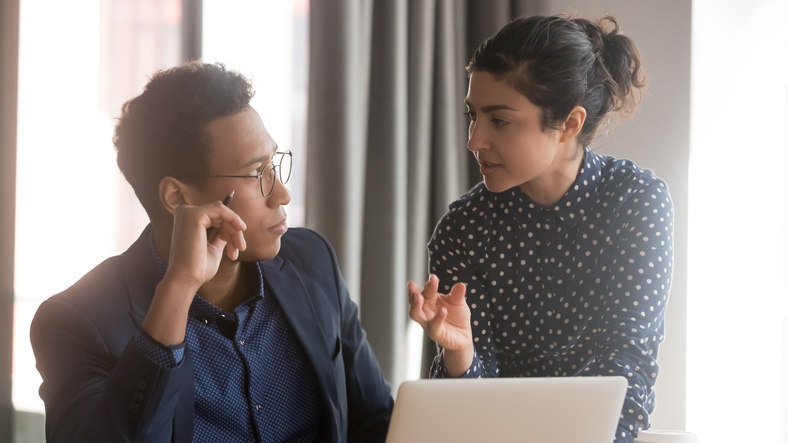 Indian female team leader sharing ideas with african ethnicity male colleague, associates meet in office discuss new project or creative business plan making task together, teamwork brainstorm concept. Gernative AI is changing knowledge work.